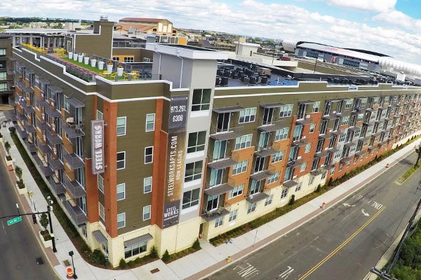 Drone image of DuxxBak Drydekk composite decking used in balcony decks for an apartment building.