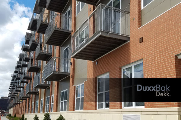 Image of a commercial apartment building with Duxxbak Dekk no drip through decks for each apartment.