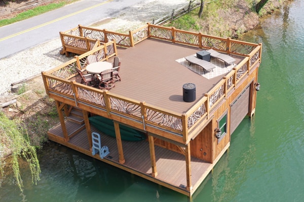 Image of a boat house and dock with upper level deck featuring DuxxBak's Commerical Dekk.