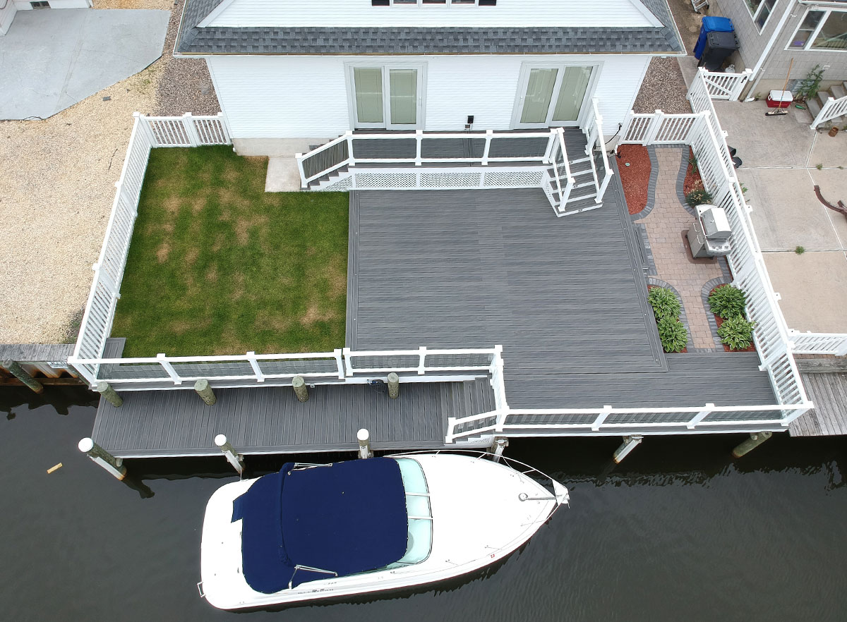 Overview view of a deck with access to navigable water featuring I.Dekk HD from DuxxBak Composite Decking.