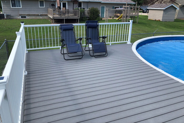 Image of a poolside composite deck built with the Optima Dekk LT board profile in River Stone.
