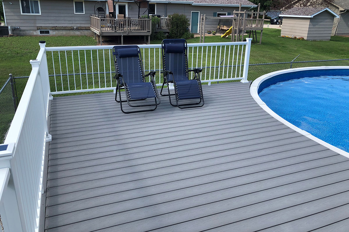 Image of a poolside composite deck build with Optima Dekk LT profile boards in a River Stone finish.